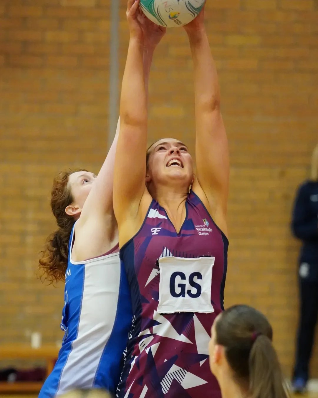 A Goal Shooter takes the ball cleanly under heavy aerial contact from a Goal Keeper