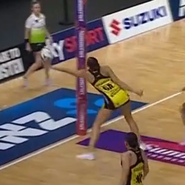 Zoomed view of the GA with the ball on one hand and her right foot still on the floor